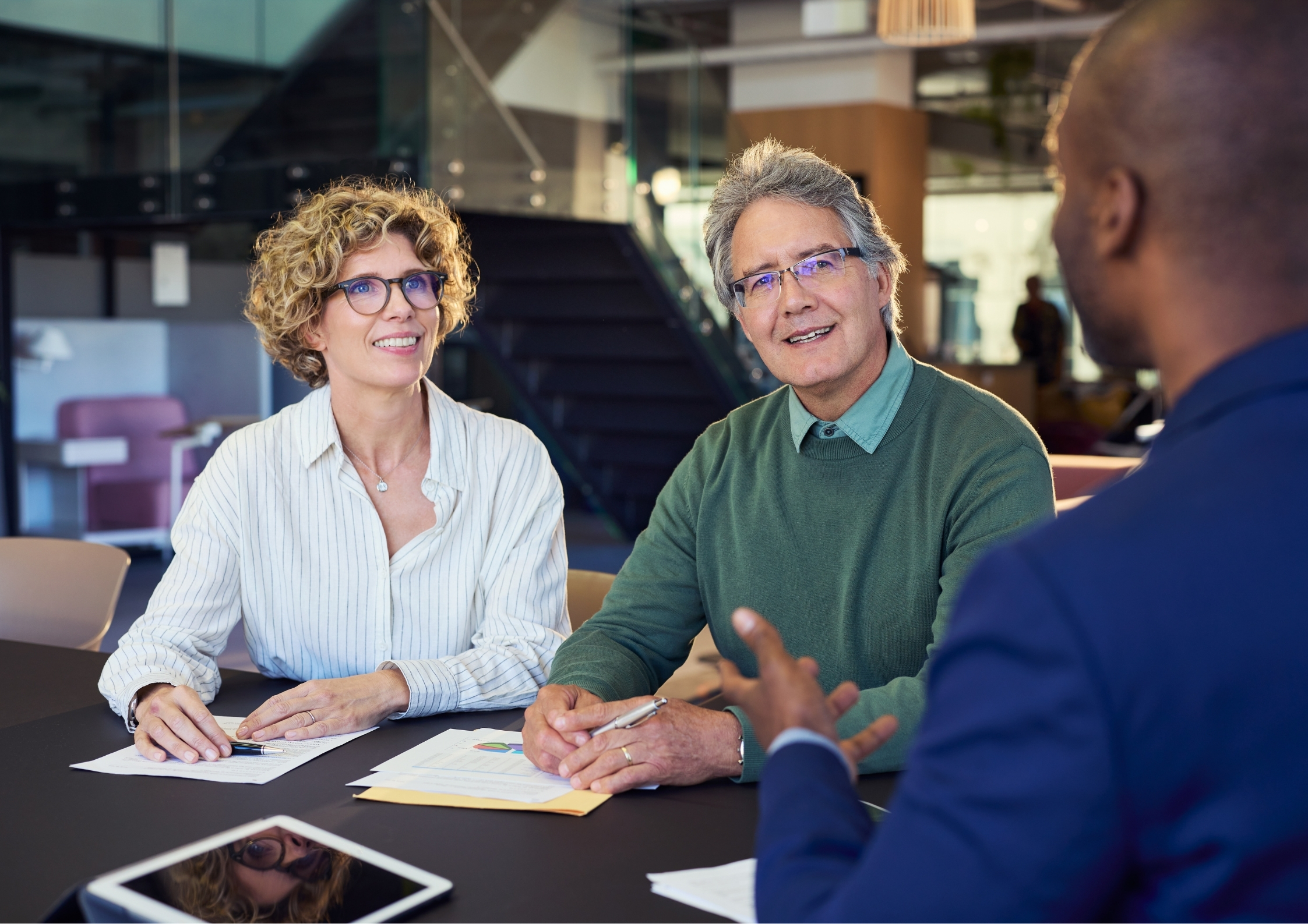 A couple having a meeting with a male agent
